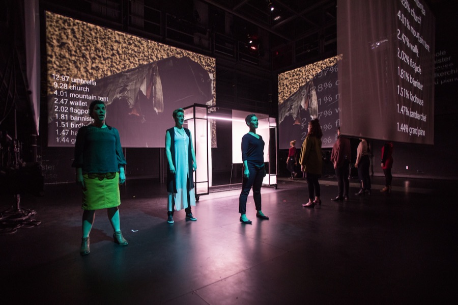 Performers surrounded by projected imagery and machine learning classification probabilities.